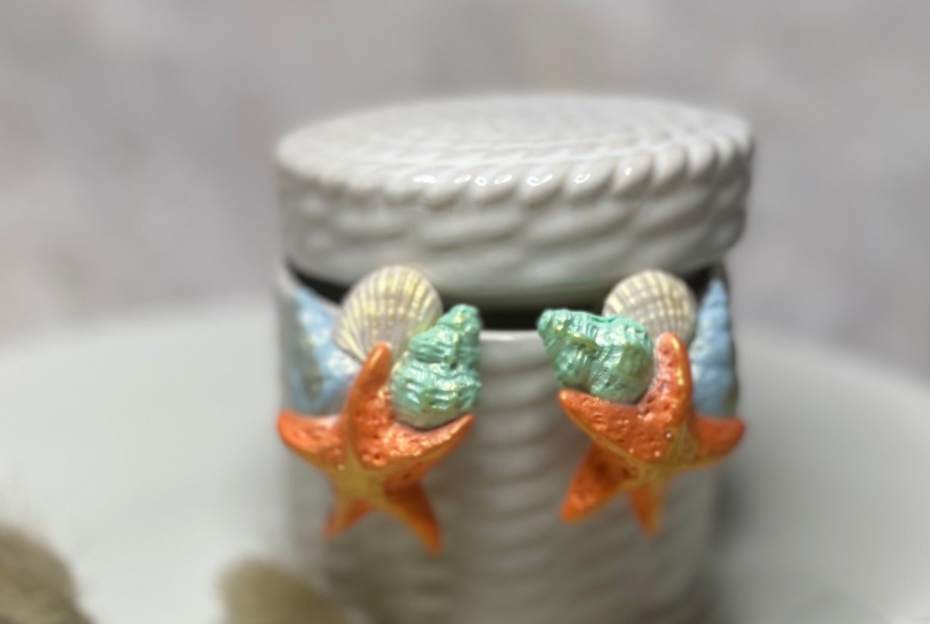 Orange star fish and seashells with gold accents